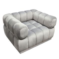 a large gray couch with pillows on it's back and armrests, sitting in front of a white background