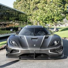 a black sports car parked in front of a building