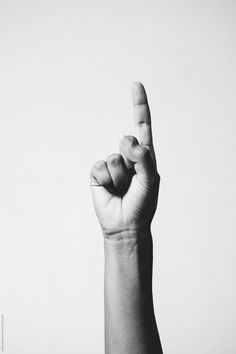 black and white photograph of a hand making the middle finger sign with their index fingers