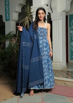 Farah smoked printed blue anarkali suit with pant and dupatta set is perfect for a festive season . Cotton cambric fabric makes it perfect for summer weather. Mirror work shell strap with gota detailing on the dupatta give the set a classic look. Product has lining. Pant has two side pockets, back elasted waistband. Cold wash and Dry clean only.Type of Work: Hand Block/ Solid Fit: Fitted at bust Model Height: 5'4 Measurements: Kurta- 52.25" Pants- 36.25" Dupatta- 95.75" SKU#: 11703066BL Disclaim Bridal Suits Punjabi, Cotton Dress Indian, Blue Anarkali, Bridal Suits, Desi Fits, Heavy Dupatta, Suits Punjabi, Trendy Outfits Indian, Outfits Indian