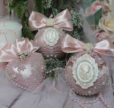 some pink ornaments with bows and pearls on them