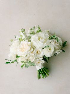 a bouquet of white flowers sitting on top of a table