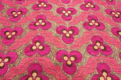 a pink and brown flowered design on fabric