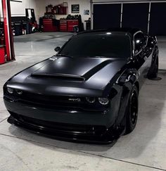 a black sports car parked in a garage