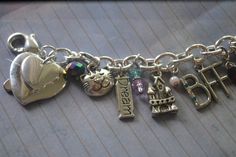 🏆 Bestseller! Tell YOUR story through charms. Each bracelet is custom made to order, personalized to your person and occasion. Unlike others, our bracelets are NOT mass produced and will not look like any other. Each bracelet comes with 10 total charms plus beads and bling to compliment your charms. (Additional charms may be added). This charm bracelet was made for a client's BFF who was moving to another state. Each charm symbolizes the fun times they shared together - the beach, champagne, fa Personalized Metal Bracelets In Cute Style, Themed Jewelry With Dangling Charms For Gifts, Themed Jewelry With Dangling Charms As Gift, Personalized Metal Charm Bracelet For Anniversary, Cute Silver Charm Bracelet For Birthday, Cute Silver Bracelet For Birthday Gift, Personalized Silver Charm Bracelet For Birthday, Personalized Silver Charm Bracelet Birthday Gift, Nickel-free Themed Charm Bracelet As Gift