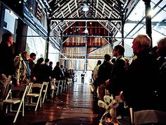 a group of people sitting in chairs next to each other inside of a large building