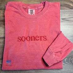 The Comfort Colors long sleeve crew neck t-shirt is the perfect choice to show your school spirit!  This is designed for Sooner fans - a crimson shirt with crimson thread.  It's perfect for any gameday celebration with friends, family, or attending an event. This shirt comes in many colors and can be customized to your liking.  If you're interested in another color, please reach out so that I can get that ordered for you. Be sure to look at other available t-shirts and sweatshirts by clicking here: https://www.etsy.com/shop/405Stitches?section_id=42561588. School Spirit Shirts Embroidered, College T-shirt With Embroidered Graphics For School Spirit, School Spirit T-shirt With Embroidered Graphics For Fall, School Spirit T-shirt With Embroidered Graphics, Long Sleeve T-shirt With Embroidered Text For School Spirit, Boomer Sooner, Sports Shirt, Tone On Tone, School Shirts