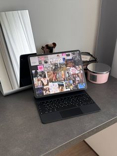 an open laptop computer sitting on top of a counter