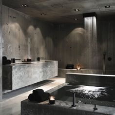 a bath room with a large tub next to two sinks and candles on the counter