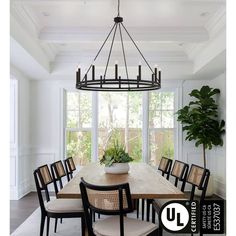 a dining room table with chairs and a potted plant on top of the table