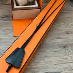 an orange box with a black leather handle