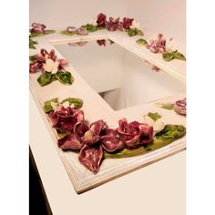 a mirror with flowers painted on it