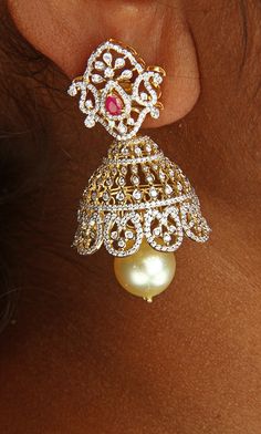 18 Karat Gold '2 in 1' Detachable Diamond Jhumkas - Diamond Dangle Earrings with Color Stones & South Sea Pearls
  This product has Inter Changeable Stones in the Earrings
  Note: Only the front side has Diamonds as shown in the picture, the back part of the Jhumka which is not visible from the front is only Gold without Diamonds


Enhance Your Glamour with 18 Karat Gold Diamond Jhumkas  Indulge in luxury with our exquisite 18 Karat Gold '2 in 1' Detachable Diamond Jhumkas, crafted with precisio Yellow Gold Chandbali Jhumkas For Reception, Festive Diamond Jhumkas With Latkans, Gold Chandbali Jhumkas With American Diamonds, Gold Chandbalis With American Diamonds For Festivals, Yellow Gold Jhumkas For Reception And Festivals, Temple Jewelry American Diamond Jhumkas With Latkans, Gold Diamond Bridal Earrings With Latkans, Gold Bridal Earrings With Diamond Latkans, Diamond Gold Jhumkas For Reception