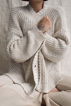 This is our Helga Cardigan. Designed to soften the challenges of everyday life, this cool and comfy knit has a chunky structure that is soft, loving and full of personality. Its weight will shape to the uniqueness of your body. The natural fibres make it a dream to wear. Perfect piece for Autumn and Winter to keep you warm but also perfect for the cool evenings of Summer and Spring. A great weight that just feels like you’re being held and hugged the whole time you wear it and it just falls on t Winter Knit Outfit, Yoga Flare Pants, Sustainable Womens Clothing, Soft Knit Cardigan, Cardigan Design, Fabric Journals, Organic Cotton Yarn, Slow Fashion Brands, Organic Cotton Clothing