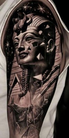 a man's arm with tattoos on it and an image of the egyptian god