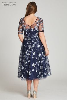 Perfect for cocktail attire events or black tie wedding, this tulle tea length navy and multicolored floral embroidered dress is both flattering and fun. The sheer illusion neckline elongates the torso and the a-line skirt narrows the waist. The light airy fabric makes dancing the night away a breeze. Tea length Elbow length sleeves Illusion neckline Pair with diamond or sapphire jewelry Fit: True to size Length: Knee to Tea length Black Tie Wedding Guest Dress Spring, Tulle Cocktail Dress, Tea Length Bridesmaid Dresses, Plus Size Gowns, Floral Cocktail Dress, Floral Embroidered Dress, Cocktail Attire, Embroidered Tulle, Illusion Neckline