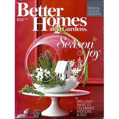 the cover of better homes and gardens magazine with a house in a glass bowl filled with flowers