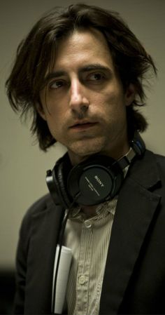 a man with long hair wearing headphones