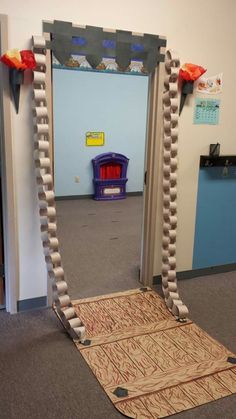 a room with a door that is made to look like an arch and some decorations on the floor