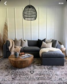 a living room filled with furniture and a rug on top of a wooden coffee table