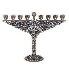 an ornate silver menorah with eight candles on the top and four smaller ones in the middle