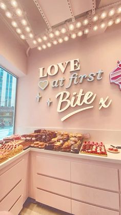 there is a buffet with lots of food on display in front of the sign that says love at first bite