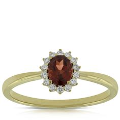 Halo style garnet and diamond ring in 14K yellow gold, Diamonds total 1/10 carat total weight. Garnet And Diamond Ring, Halo Style, Ring Fit, Perfect Engagement Ring, Ring Size Guide, Oval Diamond, Cleaning Jewelry, Round Diamonds, Jewelry Shop