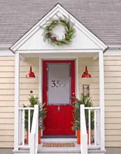 a red front door with wreaths on it