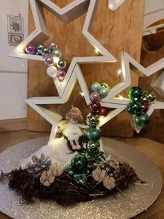 an ornament is placed on top of a table with ornaments and lights around it