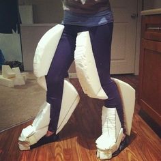 a woman standing on top of a white object in the middle of a living room