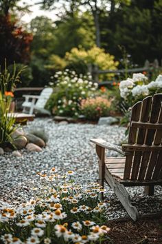 a wooden bench sitting in the middle of a garden filled with flowers and plants on top of gravel