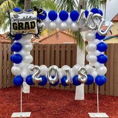 balloon arch with congratulations sign and balloons in the shape of numbers