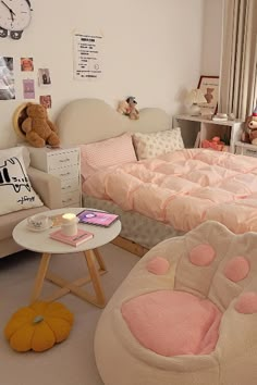 a bedroom with pink and white bedding, teddy bear furniture, and other items