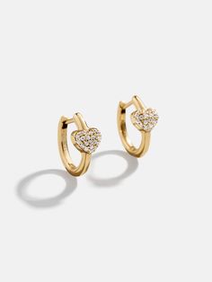 Show some love with the 18K Gold Heart Earrings. These dainty studs, crafted from 18k gold plated sterling silver and sparkling cubic zirconia stones, add a touch of romance to any look. Pair with other gold earrings or let them shine solo — either way, they’re sure to make hearts flutter. Gold Heart Earrings, 2024 Wishlist, Gold Heart Earring, Heart Flutter, Dainty Studs, Fine Earrings, Gold Heart, Heart Of Gold, Gold Plated Sterling Silver