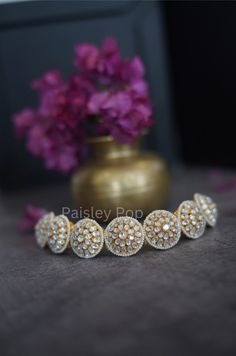 If you want to wear different eras and culture and carry it on your wrist, the Indian Polki Bracelet is a dream accessory.  Its floral-shaped motif encrusted with gajra polki is outlined with shell pearls that symbolize devoted affection, passion, and purity. This enchanting floral-inspired Bracelet is a true model of absolute luxury and class.          Closure - Lobster Handcrafted in Jammu and Kashmir Paisley Pop travels the depths of India to learn techniques and crafts from deep down the local markets and villages. We give utmost importance to our quality and packaging. Our goal is to make sure you get what you are looking for and for your experience to be a special and memorable one. We are ready to help and advise you through your purchase.  I T ' S  A W E S O M E * Ethically Sourced Polki Bracelet, Sabyasachi Jewelry, Bracelet Indian, Sabyasachi Jewellery, Design Bracelet, Bridal Bangles, Jammu And Kashmir, Free Earrings, Victorian Jewelry