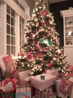 a christmas tree with presents under it