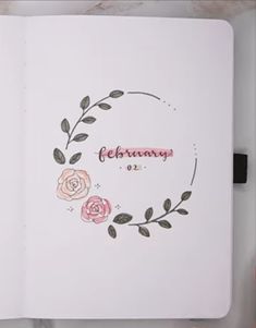 an open notebook with flowers and the words february written in pink ink on white paper