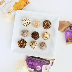 a white plate topped with lots of desserts next to a bag of cookies and milk