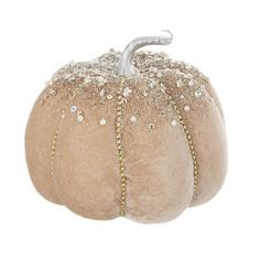 a white pumpkin with gold sequins on it