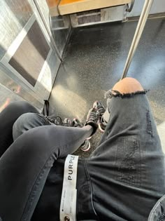 a person sitting on an escalator with their feet up