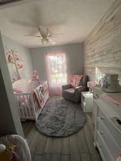 a baby's room is decorated in pink and gray