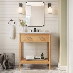 a bathroom with a sink, mirror and toiletries on the counter in front of it