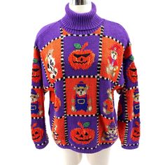 a purple and orange sweater with pumpkins on the front, sitting on a mannequin's head