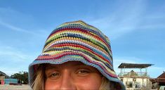 a woman wearing a multicolored knitted hat