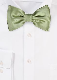 This sage solid bow tie in a solid sage color is sure to become your go-to new favorite accessory for your blue suits. The deep green color is brought out to its full potential when paired with a jacket in a darker shade of blue, such as navy or midnight blue. This bow tie is ideal for both informal and formal settings due to the satin finish fabric from which it is constructed. The fabric exudes a magnificent sheen, making it suitable for both settings. Elegant Green Ties For Spring, Elegant Green Tie For Spring, Elegant Green Spring Ties, Classic Green Ties For Formal Occasions, Classic Green Formal Tie, Elegant Green Suit And Tie Accessories For Spring, Classic Green Ties For Black Tie Events, Classic Green Ties For Black Tie Occasions, Classic Green Tie For Black Tie Occasions