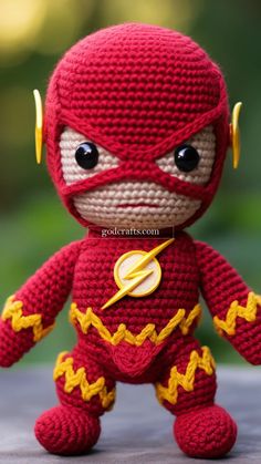 a crocheted stuffed toy with a flash on it's chest and eyes