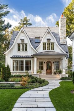 a white house with lots of windows and landscaping