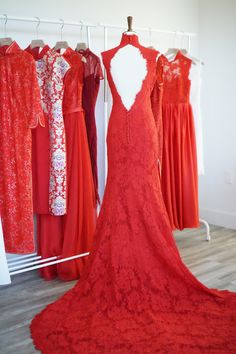 a red dress is on display in front of other dresses