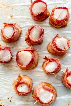 bacon wrapped in toothpicks on a sheet of wax paper and ready to be cooked