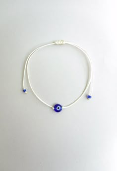 Adjustable Spiritual Braided Bracelet With Evil Eye, Adjustable Braided Evil Eye Bracelet For Spiritual Protection, Adjustable Spiritual Evil Eye Braided Bracelet, White Waxed Cord Friendship Jewelry, White Adjustable Nylon Cord Jewelry, Adjustable Evil Eye Friendship Bracelet, Adjustable Evil Eye Spiritual Jewelry, Adjustable Spiritual Evil Eye Jewelry, Adjustable Spiritual Waxed Cord Jewelry